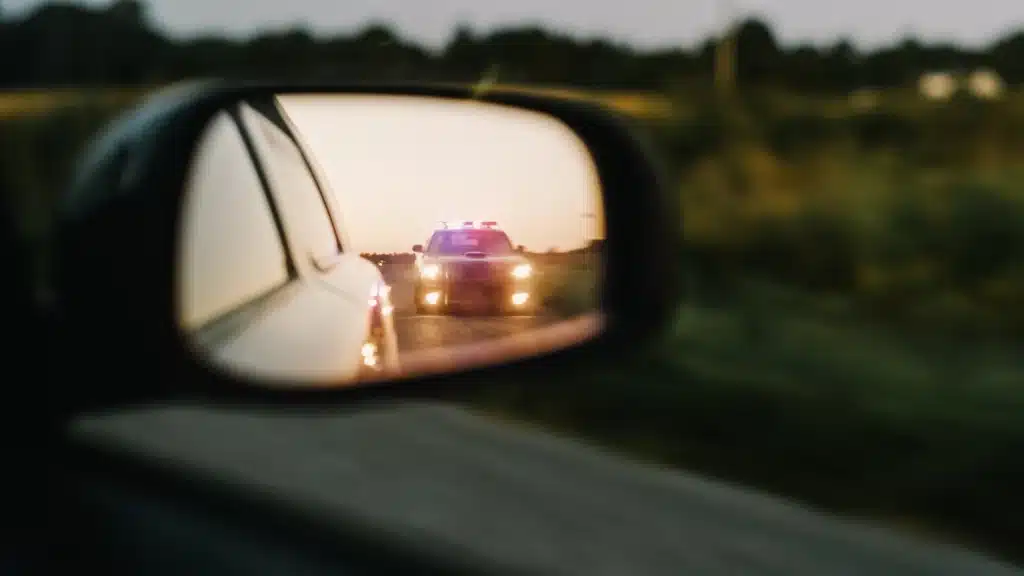Police car in side mirror reflection - Returning Drivers Courses for drivers on the Gold Coast Qld